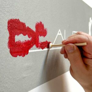 Anwendung einer Malerschablone an der Wand mit selbstklebender Folie